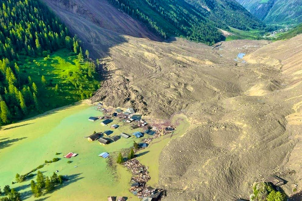 The village of Blatten is almost completely submerged under debris and water.