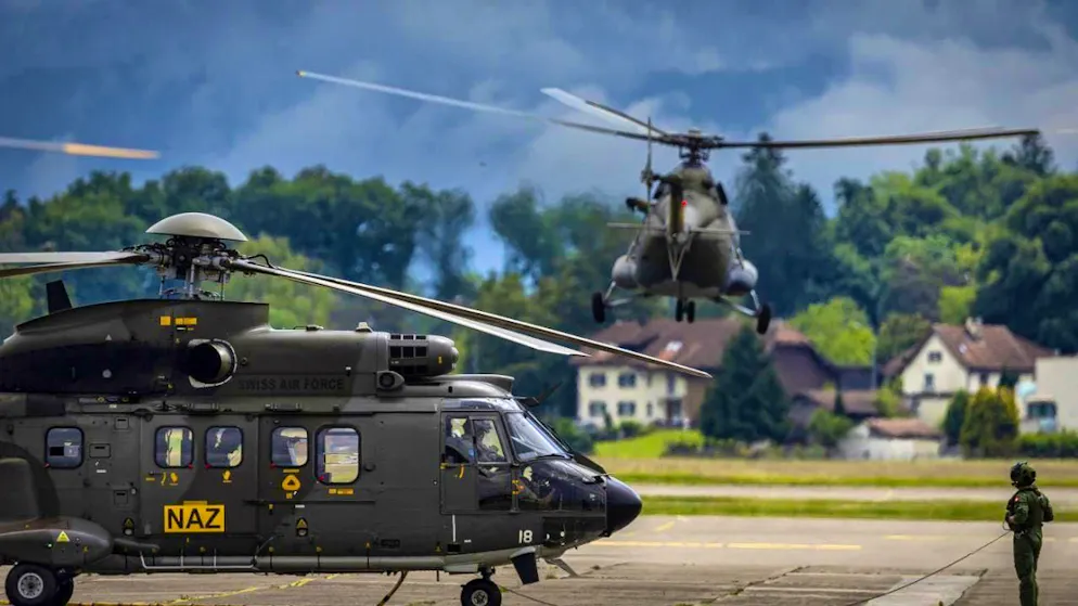 Helicopters from the Swiss (left) and Czech air forces take off as part of the radioactivity measurement flights at Dübendorf military airfield.