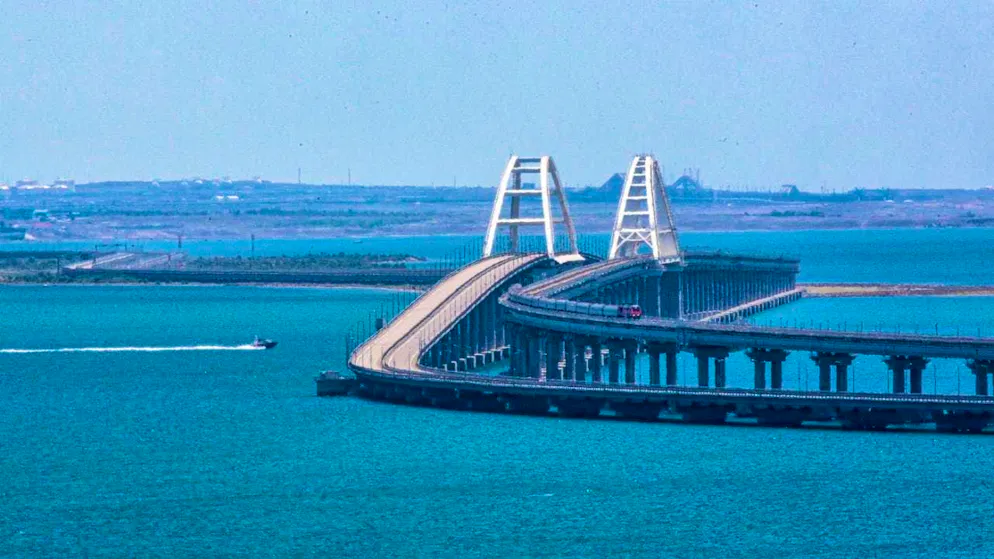 ARCHIVE - A freight train crosses the railroad link of the Crimean Bridge, which connects the Russian mainland and the Crimean peninsula across the Kerch Strait. Photo: -/AP/dpa