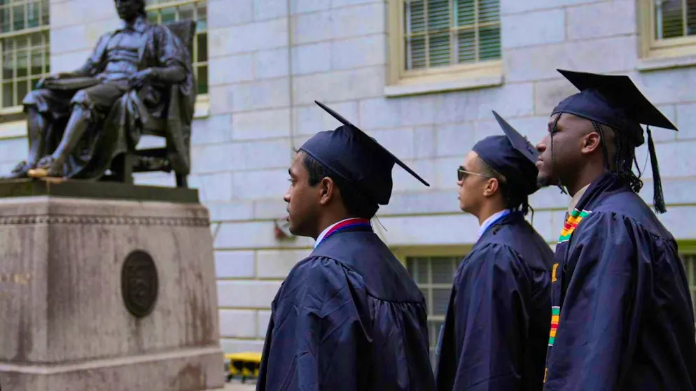 Students walk through Harvard Yard during the degree conferral ceremony at Harvard University. Photo: Charles Krupa/AP/dpa