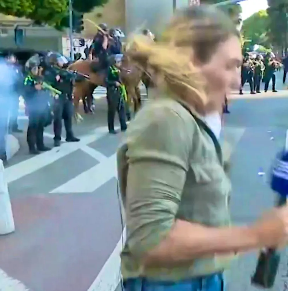 Journalist Lauren Tomasi is shot with a rubber bullet during a live broadcast.