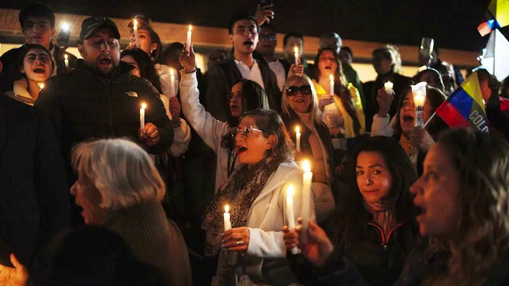 Supporters of Colombian presidential candidate Miguel Uribe, who has been shot, gather outside the hospital in Bogota.