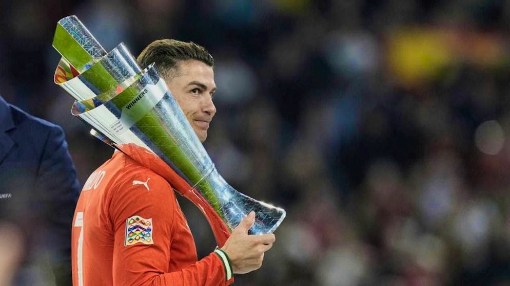 Cristiano Ronaldo casually shoulders the winner's trophy after winning the Nations League final