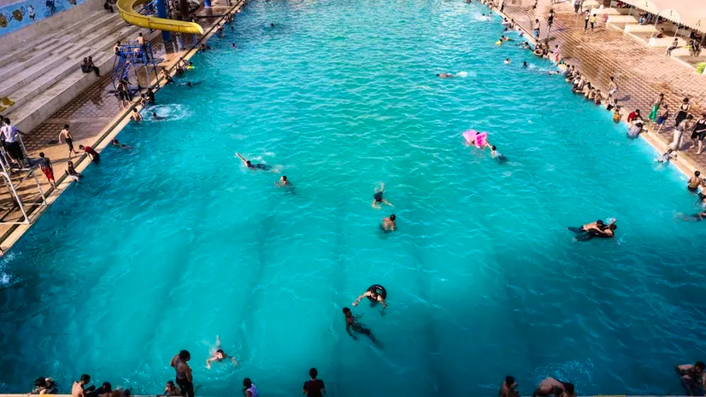 ARCHIVE - Young Syrians swim in a pool to cool off on a hot summer's day. Photo: Anas Alkharboutli/dpa