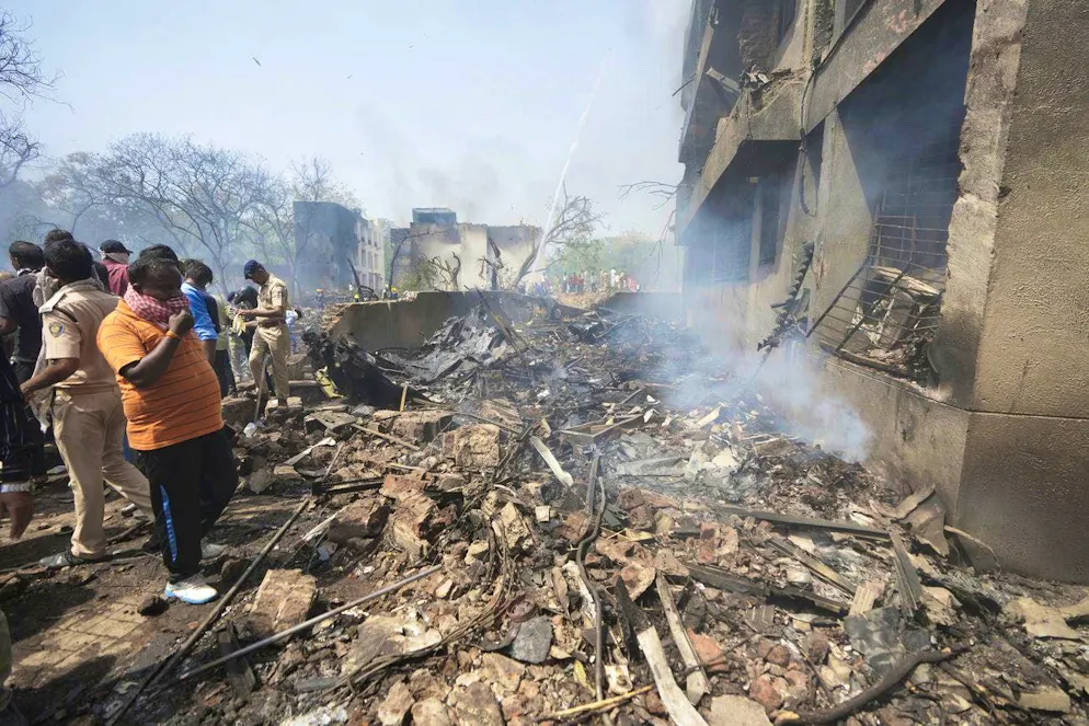 Air India plane crash. Security forces work at the crash site.