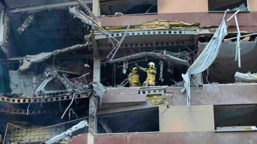 Firefighters work at the site of an explosion in a residential complex in the north of Tehran after Israeli attacks.
