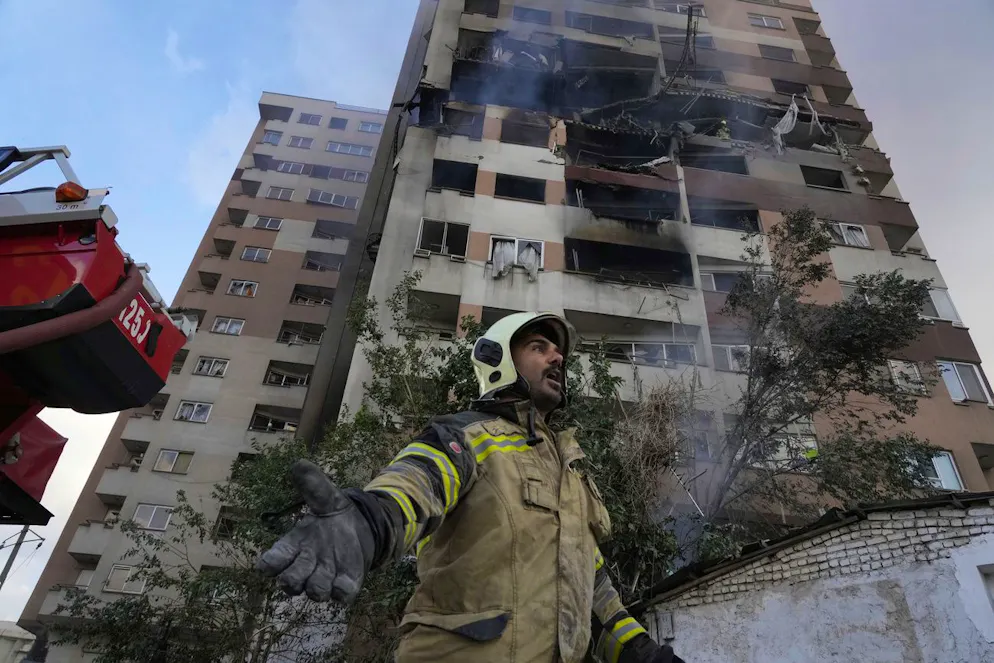 Frappes en Iran. Un pompier appelle ses collègues sur les lieux d'une explosion dans un complexe résidentiel au nord de Téhéran, en Iran, le vendredi 13 juin 2025. (AP Photo/Vahid Salemi)