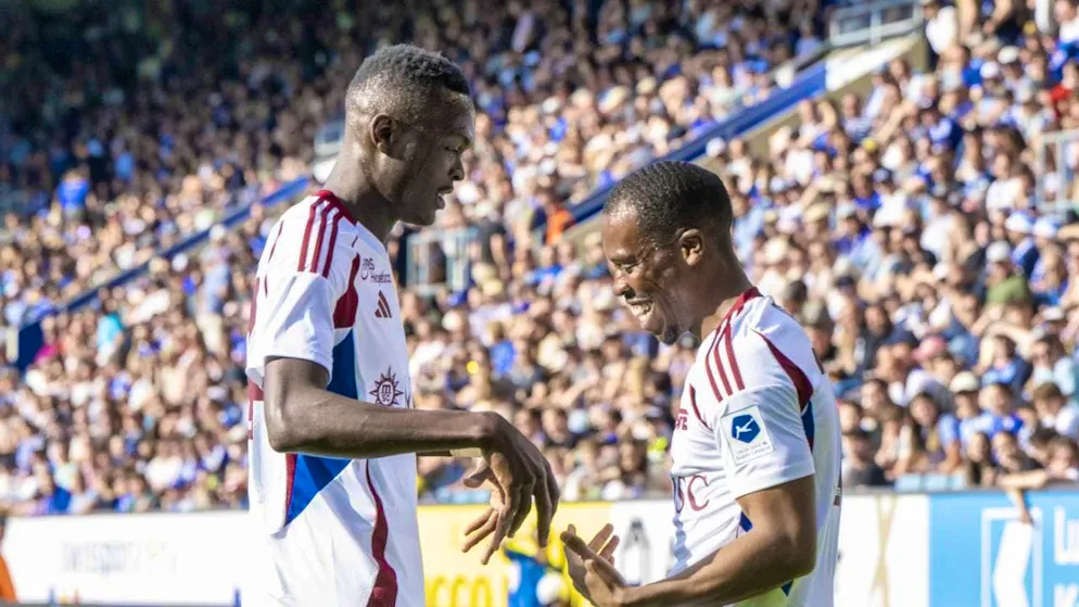 Alioune Ndoye (left) celebrates with teammate Dereck Kutesa.