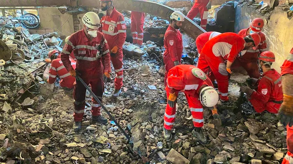 Rescue workers search for survivors after an Israeli attack on a building in Tehran.