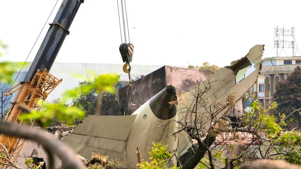 A crane lifts the tail of the Air India plane that crashed on Thursday from the roof of a building in Ahmedabad, India. Photo: Ajit Solanki/AP/dpa