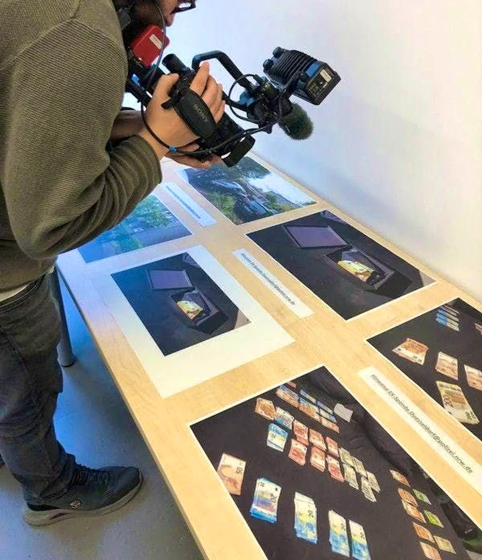 Photos of the money confiscated from a preacher are on display at a press conference. A preacher is said to have collected large donations for charitable purposes. He is now suspected of having used the money primarily for himself.