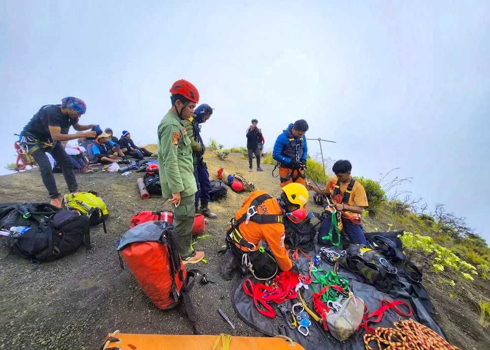 The rescue operation is made more difficult by fog and steep terrain.