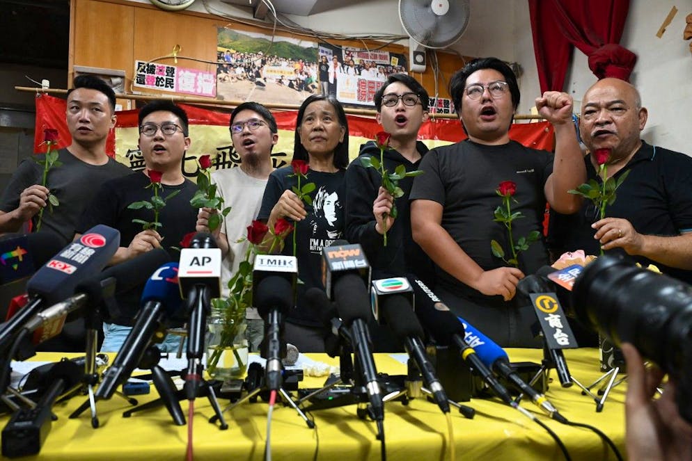 Des membres de la Ligue des sociaux-démocrates, accompagnés de leur dirigeante Chan Po-ying (au centre), scandent des slogans après une conférence de presse tenue dans leur siège à Hong Kong, le 29 juin 2025.