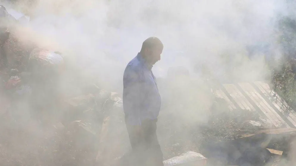 A Palestinian man stands in the ruins of his house, which was set on fire by radical settlers, in the village of Al-Mughayyir near Ramallah on April 13, 2024.