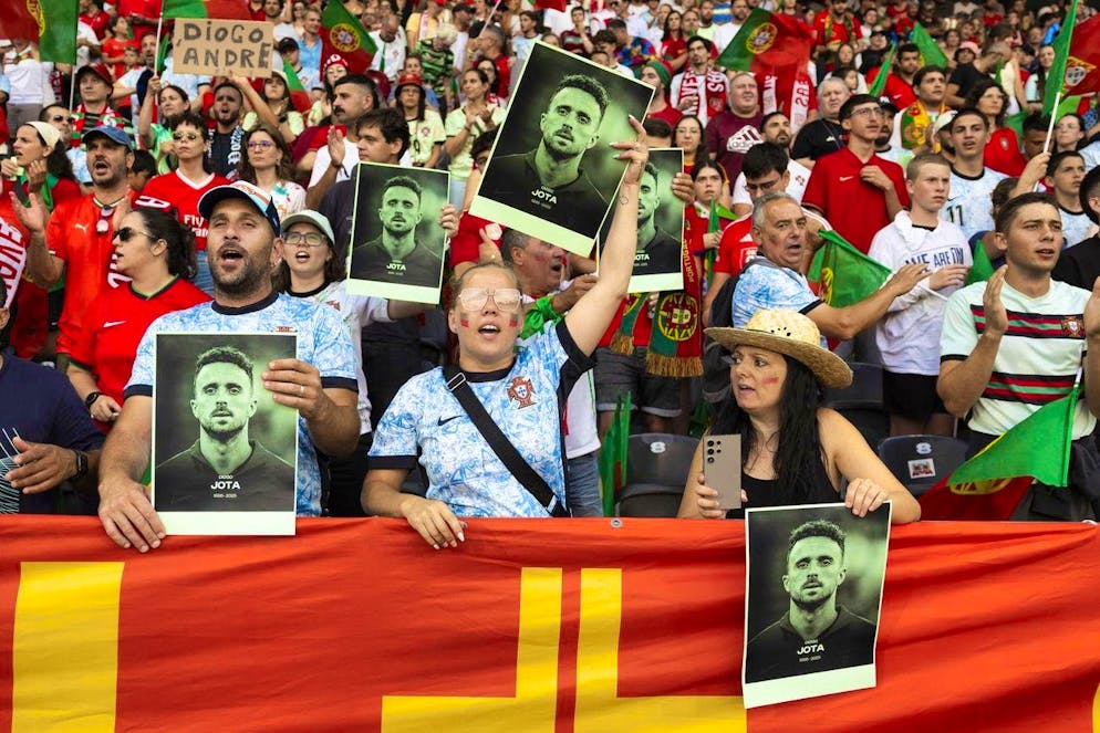 Fans hold pictures of the deceased Portuguese footballer Diogo Jota before the European Championship match between Spain and Portugal at the Wankdorf Stadium in Bern.