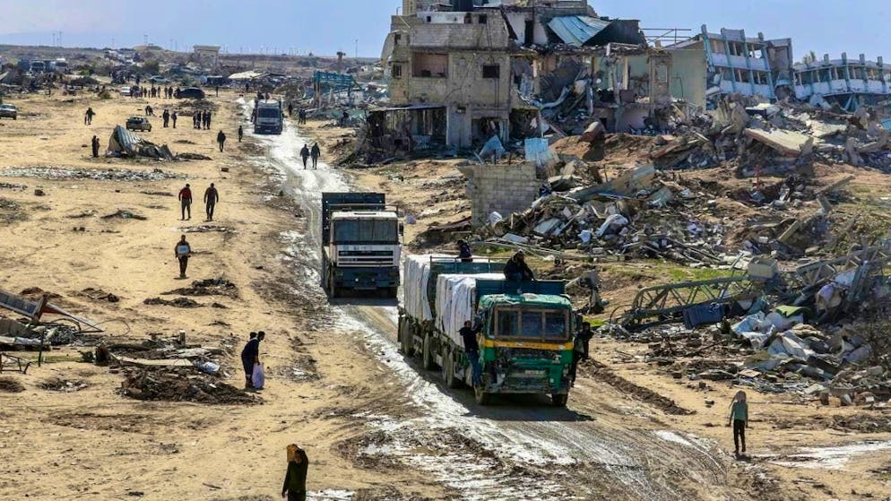Trucks carrying humanitarian aid from the United Nations Relief and Works Agency for Palestine Refugees in the Near East (UNRWA) enter the Gaza Strip at the Kerem Shalom crossing from Egypt.