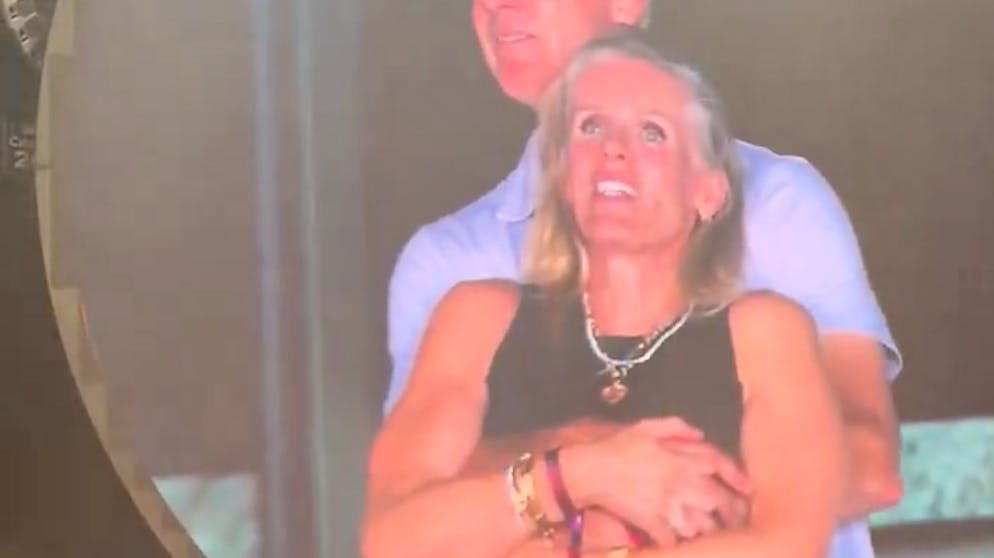 Intimate moment on the big screen. Company boss goes to a concert with an affair - then they get caught cold