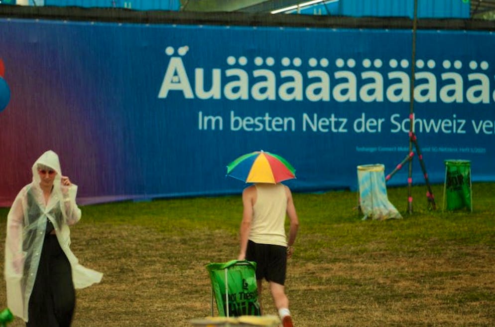 Rain at the Gurten Festival. Visitors are equipped with tippets and umbrellas.