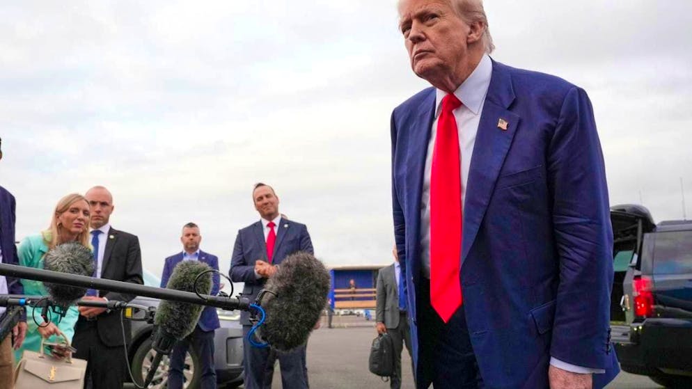 US President Donald Trump listens to media representatives after arriving at Prestwick Airport in Ayrshire, Scotland. Photo: Jacquelyn Martin/AP/dpa
