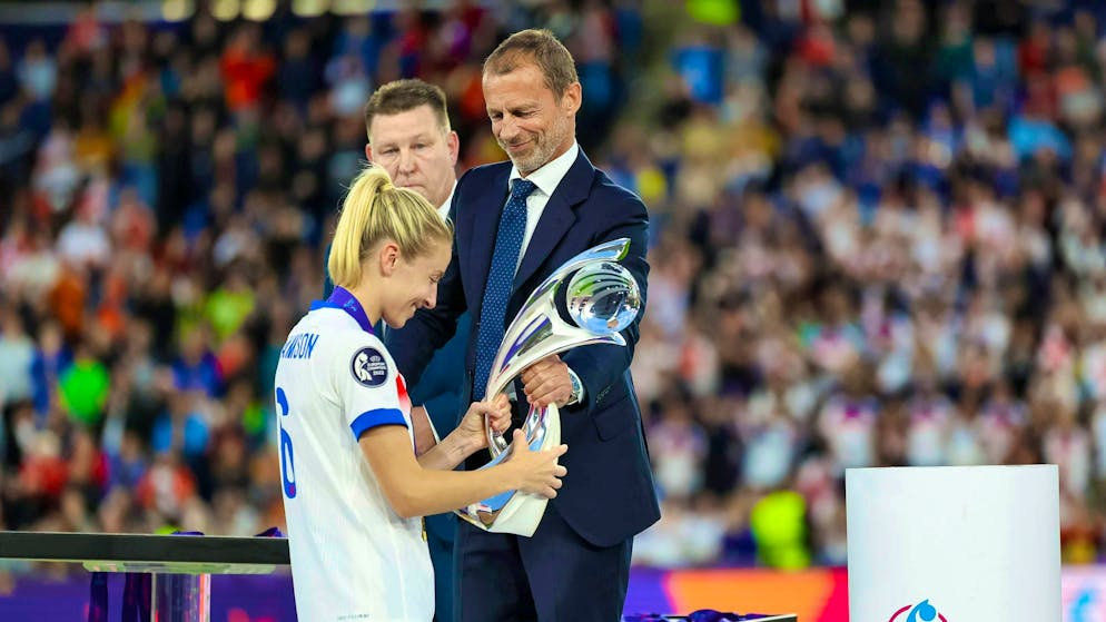 UEFA President Aleksander Čeferin presents England captain Leah Williamson with the European Championship trophy.
