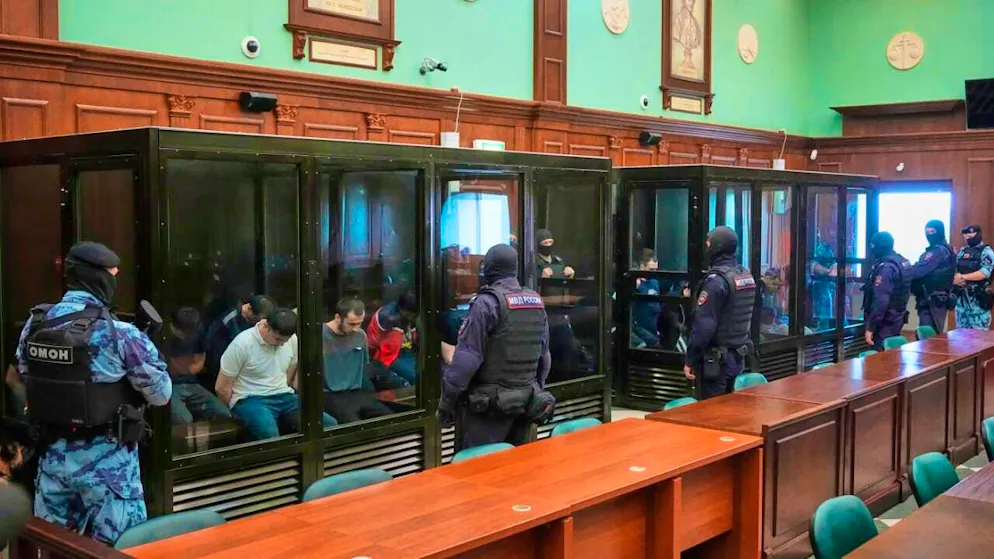 Suspects accused of being involved in the Islamist terrorist attack on a Moscow concert hall that left more than 140 people dead on March 22, 2024, sit in a glass cage before a hearing at the 2nd Western District Military Court in Moscow. Photo: Pavel Bednyakov/AP/dpa