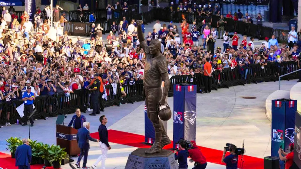 A statue for the quarterback legend - Gallery. Alluding to Brady's back number, the statue is 12 feet tall (around 3.66 m). Including the base, it has a height of 17 feet (around 5.18 m)