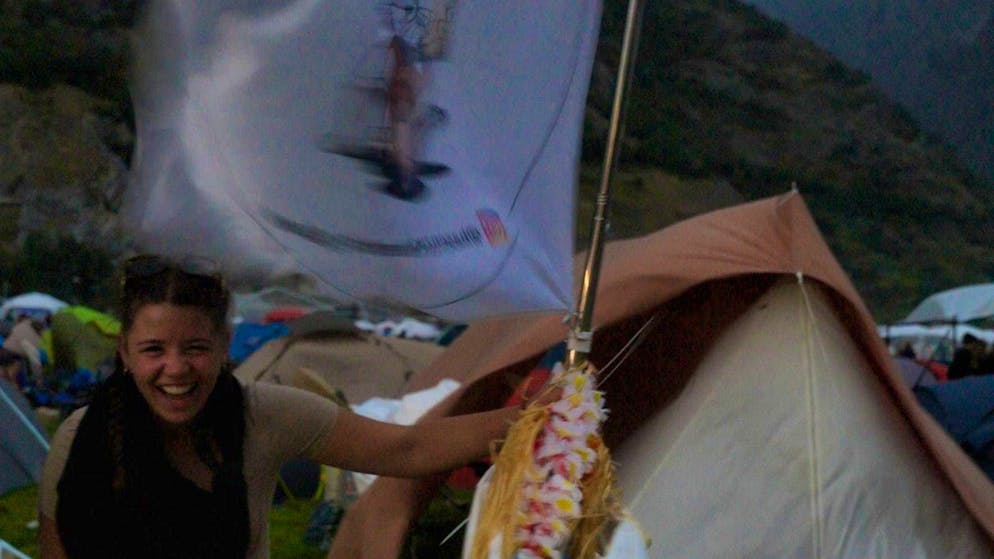 Fun in the storm: festival-goers are not fazed by a little wind like this.