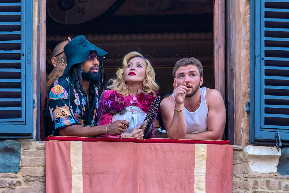 Madonna (center) with her boyfriend Akeem Morris (left) in Siena, where she watched the "Palio di Siena" horse race, which takes place every year on her birthday.