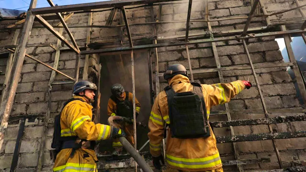 Rescue workers extinguish a fire in a store that was destroyed by a Russian missile attack. Photo: Kateryna Klochko/AP/dpa