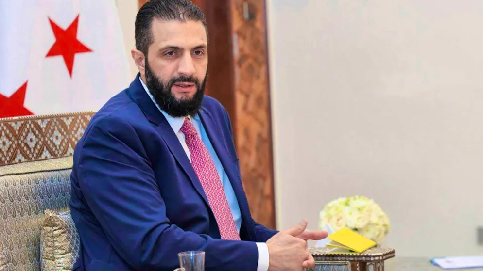 ARCHIVE - In this photo released by Syria's official news agency SANA via AP, Syrian interim President Ahmad al-Sharaa receives the final version of the provisional electoral system for the People's Assembly. Photo: Uncredited/SANA/dpa