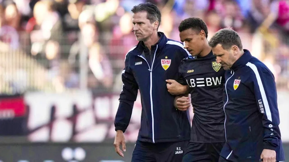 Luca Jaquez is escorted off the pitch by medical staff