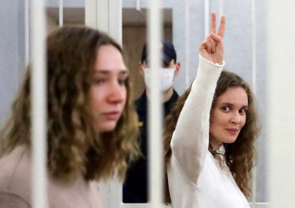 Die Jourmalistin Katerina Bachwalowa macht das Victory-Zeichen, als sie im Februar 2021 mit ihrer Kollegin Daria Chultsowa in Minsk vor Gericht steht: Frauen in Gefängnissen in Belarus kann es äusserst schlecht ergehen.