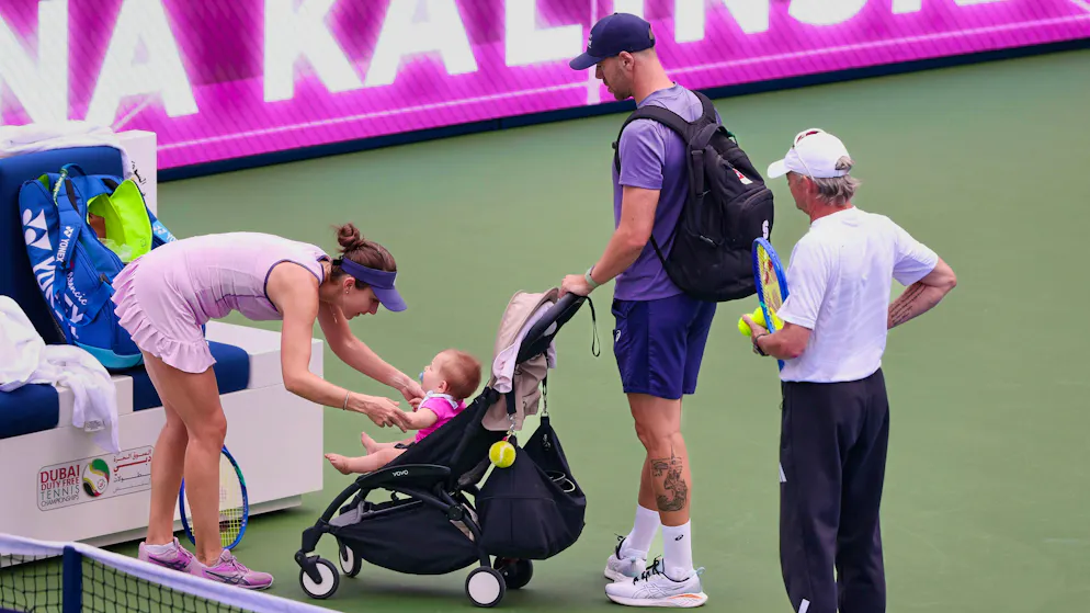 Belinda Bencic dances with baby Bella, her husband Martin Hromkovic and coach Ian Hughes look on.
