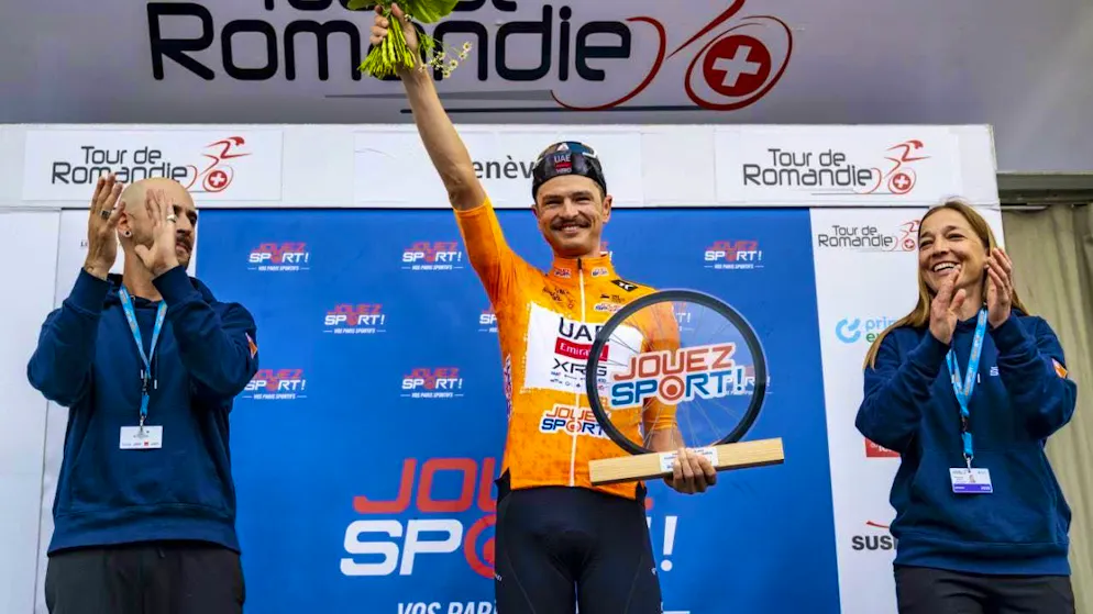 Jay Vine, pictured here at a Tour de Romandie award ceremony, wins a stage at the Vuelta for the third time in his career