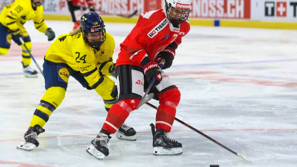 Lara Stalder (right) battling for the puck against Ebba Hedqvist from Sweden