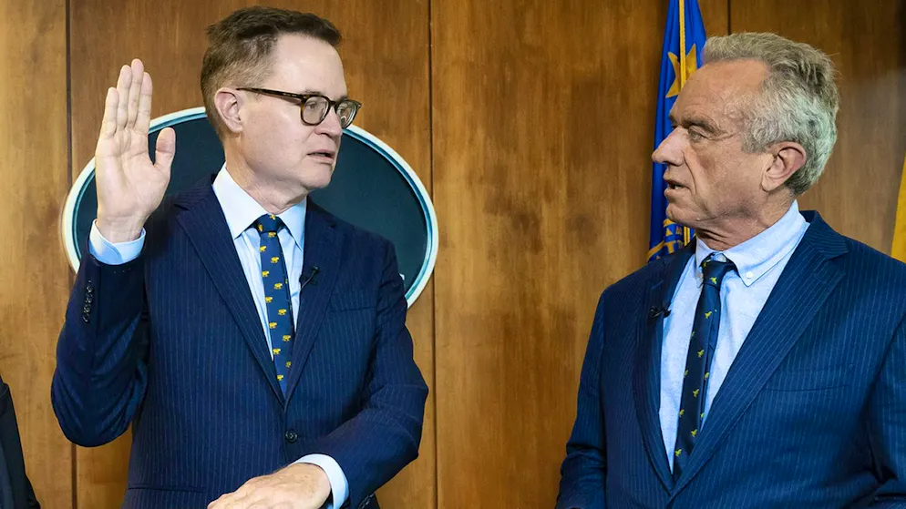 US Secretary of Health and Human Services, Robert F. Kennedy, Jr. (r.) swears in his deputy Jim O'Neill, who has no medical background but worked for conservative mega-donor and investor Peter Thiel. (June 9, 2025)