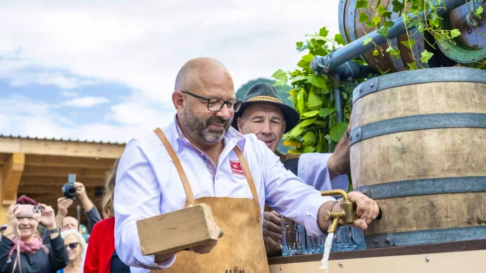 Jakob Kamm, OC President of the Swiss Wrestling and Alpine Festival (ESAF), taps a keg of beer at the official opening.
