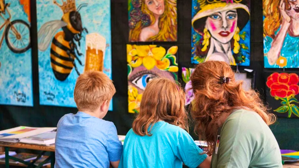 A family takes part in a painting workshop during the Red Head Days Festival in Tilburg. Photo: Virginia Mayo/AP/dpa