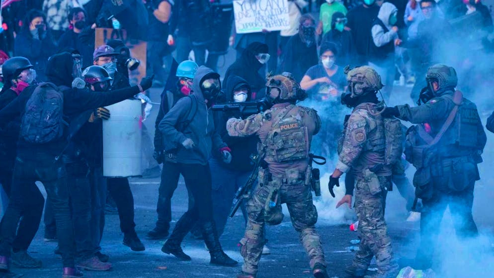 US Customs officials use tear gas against protesters during a demonstration in front of the US Customs and Immigration Enforcement (ICE) building.