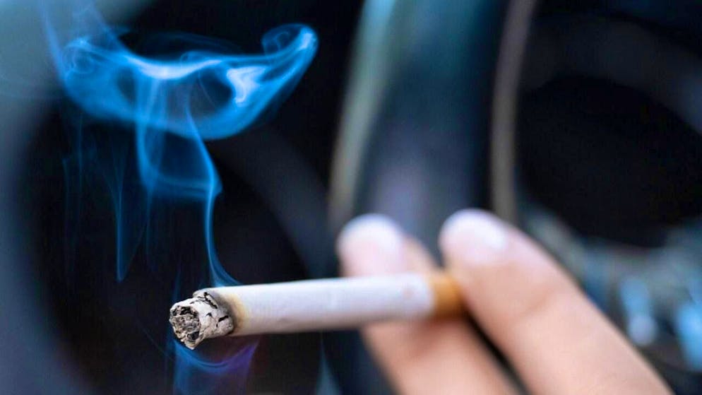 ARCHIVE - A woman sits in a car holding a cigarette. Photo: Sebastian Kahnert/dpa