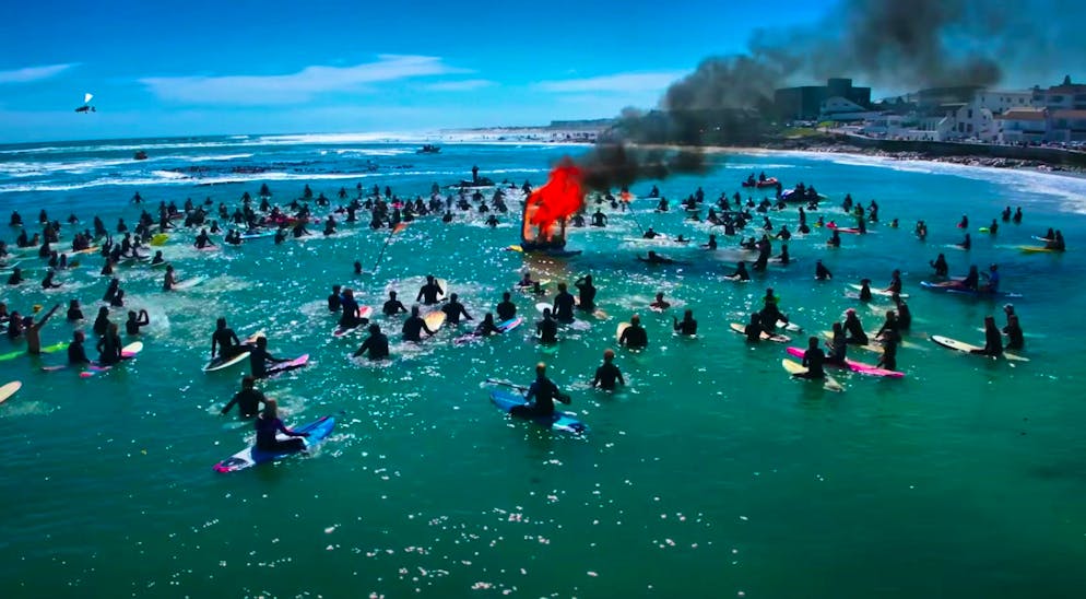 Surfers commemorate Graham Howes with a mourning ceremony.