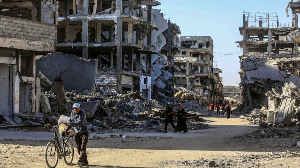 dpatopbilder - Menschen gehen durch die Ruinen, als vertriebene Palästinenser in ihre Häuser zurückkehren. Foto: Abed Rahim Khatib/dpa