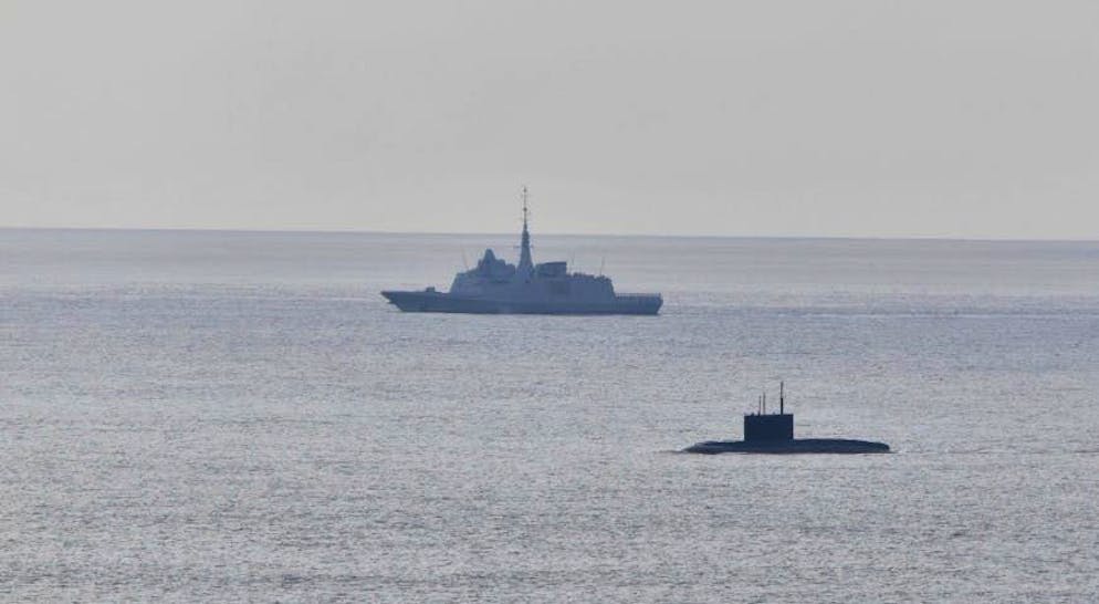 A Russian submarine (bottom right) has surfaced off the coast of France.