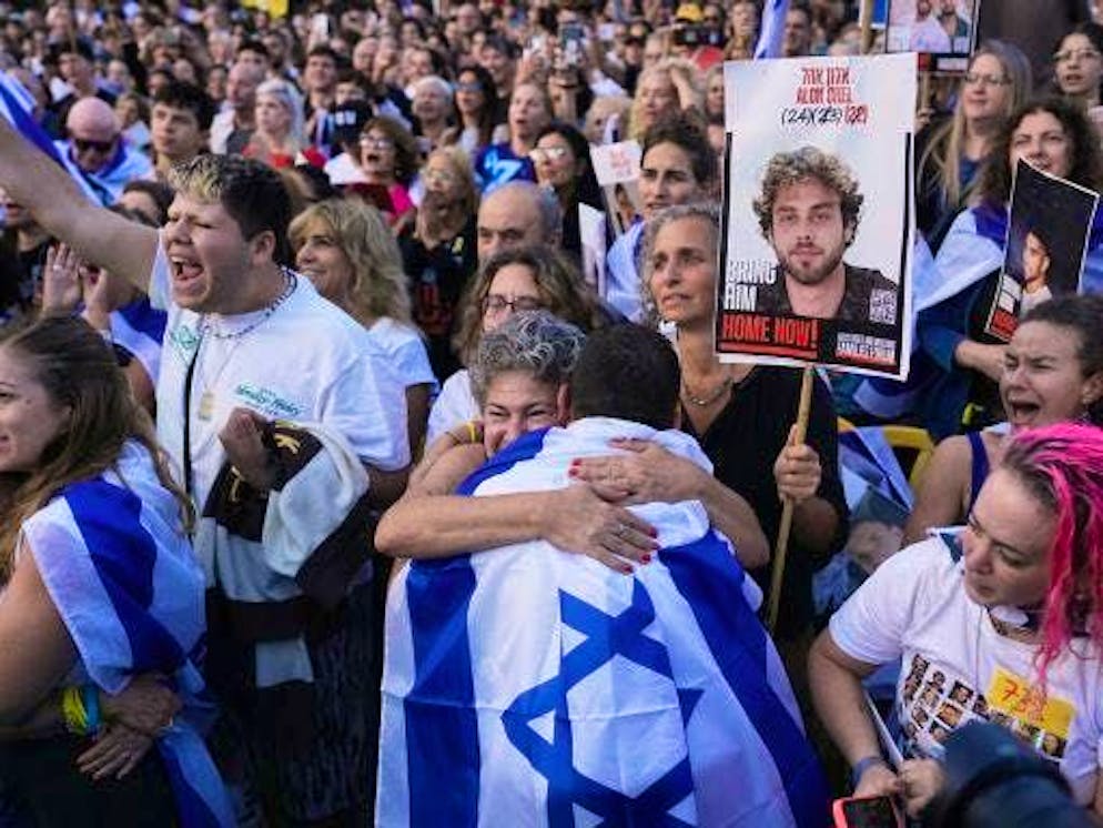 People gathered in Tel Aviv's Hostages Square before the release of the Israeli hostages. Cheers break out at the news of the release.