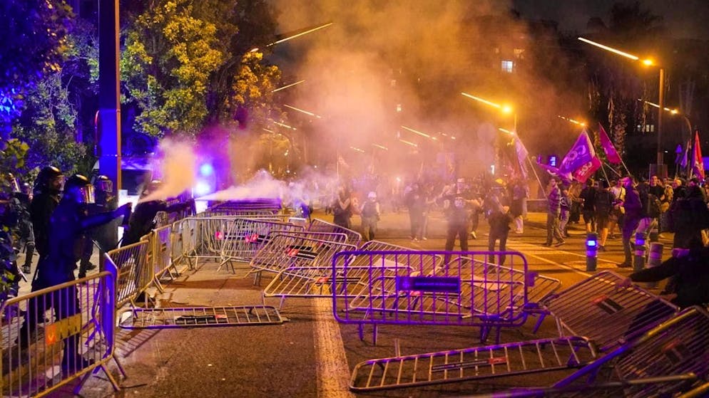 Police officers fire tear gas at demonstrators in Barcelona. Photo: Bernat Armangue/AP/dpa