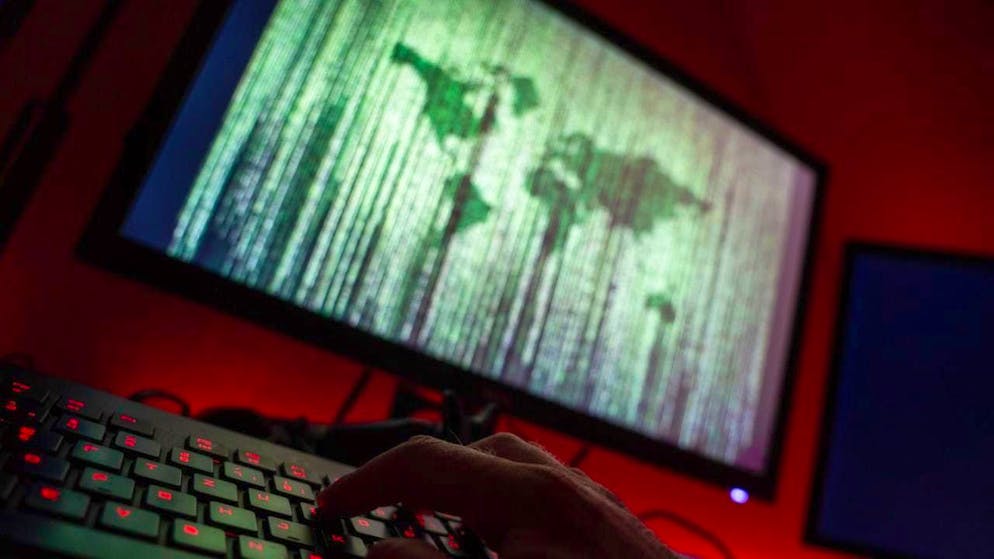 ILLUSTRATION - A man sits at a computer and types on a keyboard. Photo: Nicolas Armer/dpa