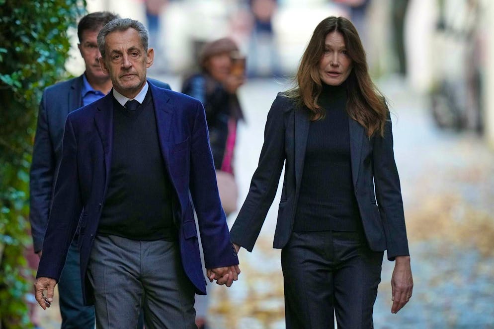 Nicolas Sarkozy and wife Carla Bruni-Sarkozy on their way to prison on Tuesday morning.