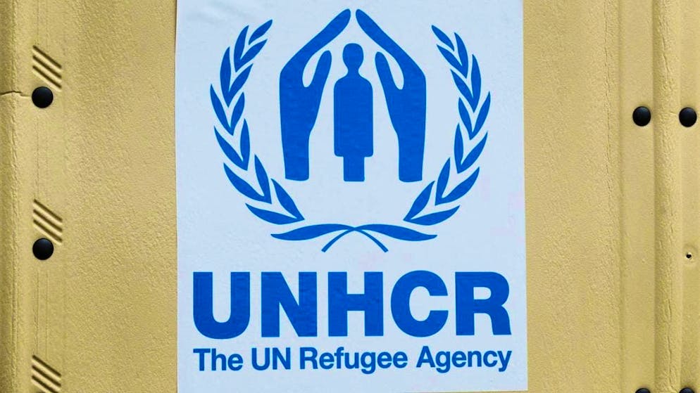 ARCHIVE - The UNHCR logo is stuck to a self-built UNHCR hut. Photo: Annette Riedl/dpa/Archive