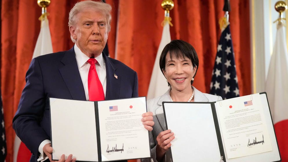 US-Präsident Donald Trump (l.) und Japans Premierministerin Sanae Takaichi am Dienstag in Tokio mit dem von ihnen unterzeichneten Abkommen.