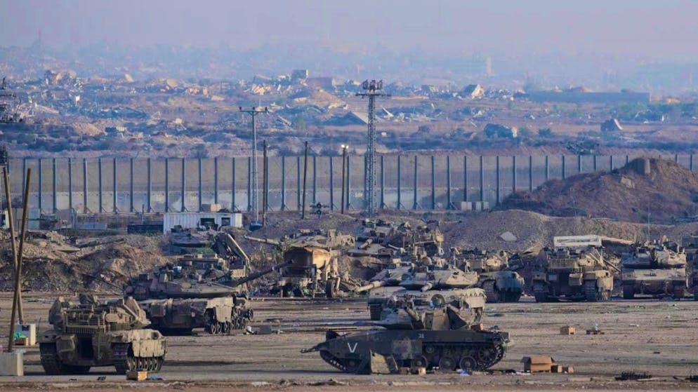 Israeli tanks are parked in a staging area near the border with the Gaza Strip in southern Israel. Photo: Ohad Zwigenberg/AP/dpa